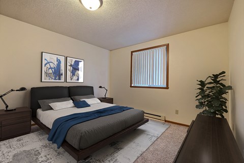 a bedroom with a bed and a dresser and a window. Fargo, ND Southgate Apartments