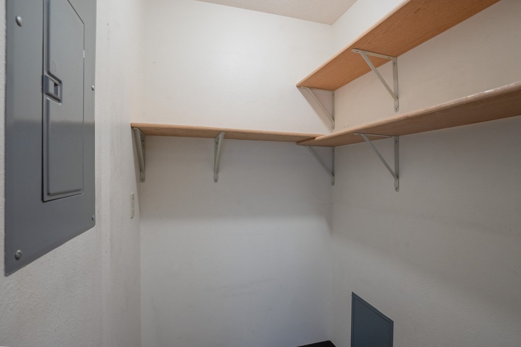 a room with white walls and a shelf on the wall. Fargo, ND Southview Village Apartments