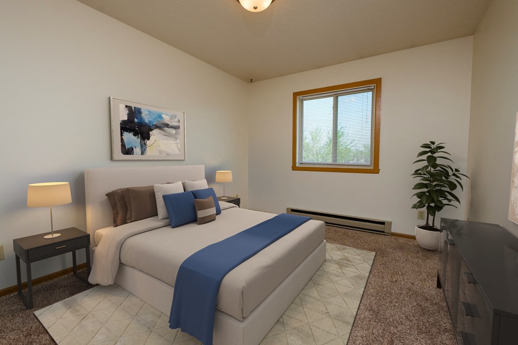 a bedroom with a bed, dresser, and window. Fargo, ND Southwind Apartments