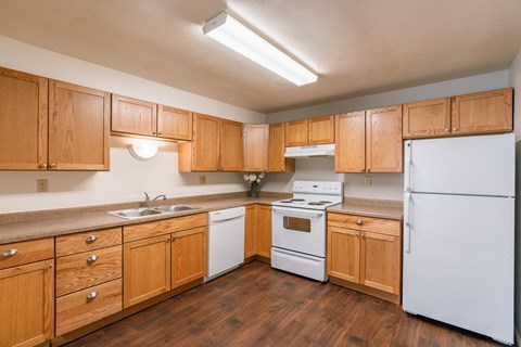 the preserve at ballantyne commons apartment kitchen with white appliances and wooden cabinets