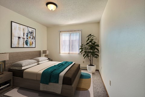 a bedroom with a bed and a potted plant. Fargo, ND Sterling Park Apartments