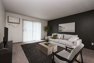 a living room with a white couch and a coffee table. Fargo, ND Stonebridge Apartments