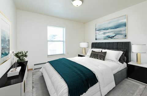 a bedroom with a large bed and a window. Fargo, ND Sunrise North