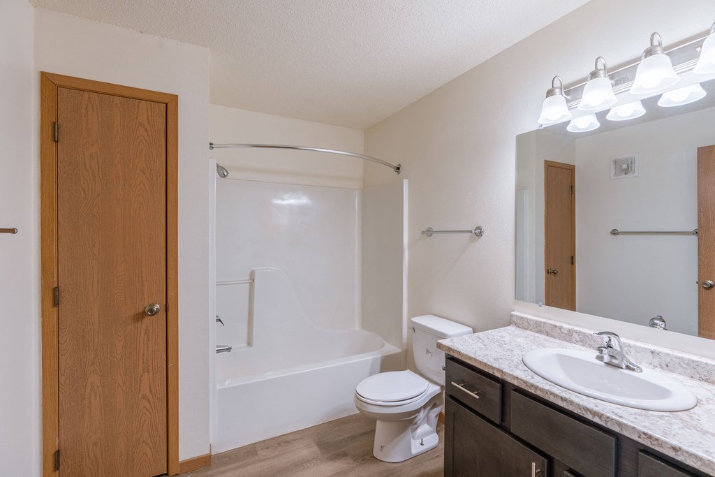 a bathroom with sink toilet and shower. Fargo, ND Sunwood Apartments