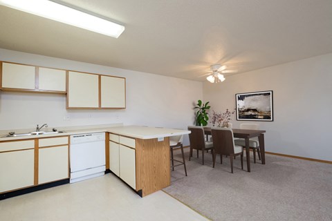 an open kitchen and dining room with a table and chairs