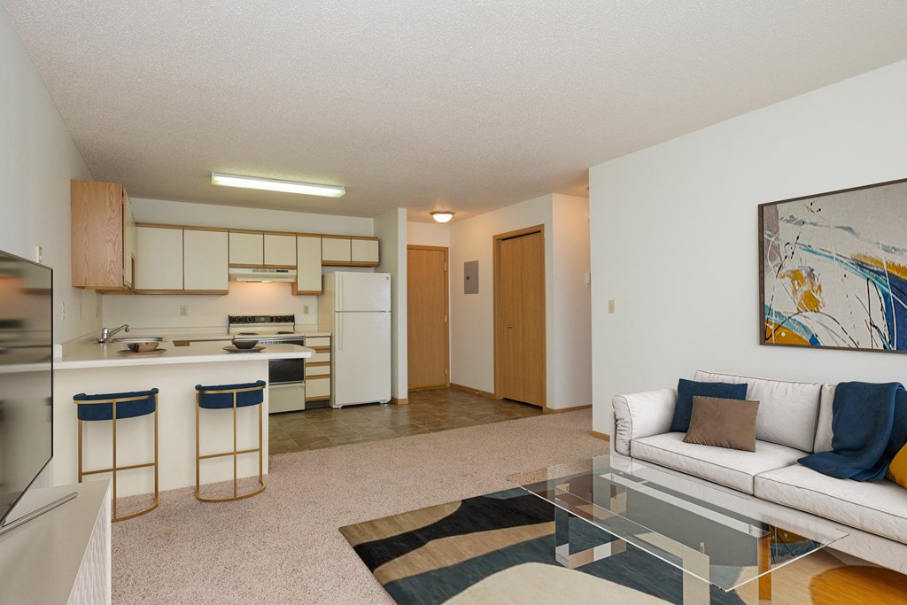 Fargo, ND Twin Parks Apartments. a living room with a white couch and a glass coffee table