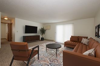 Fargo, ND Twin Parks Apartments. a living room with a couch coffee table and television