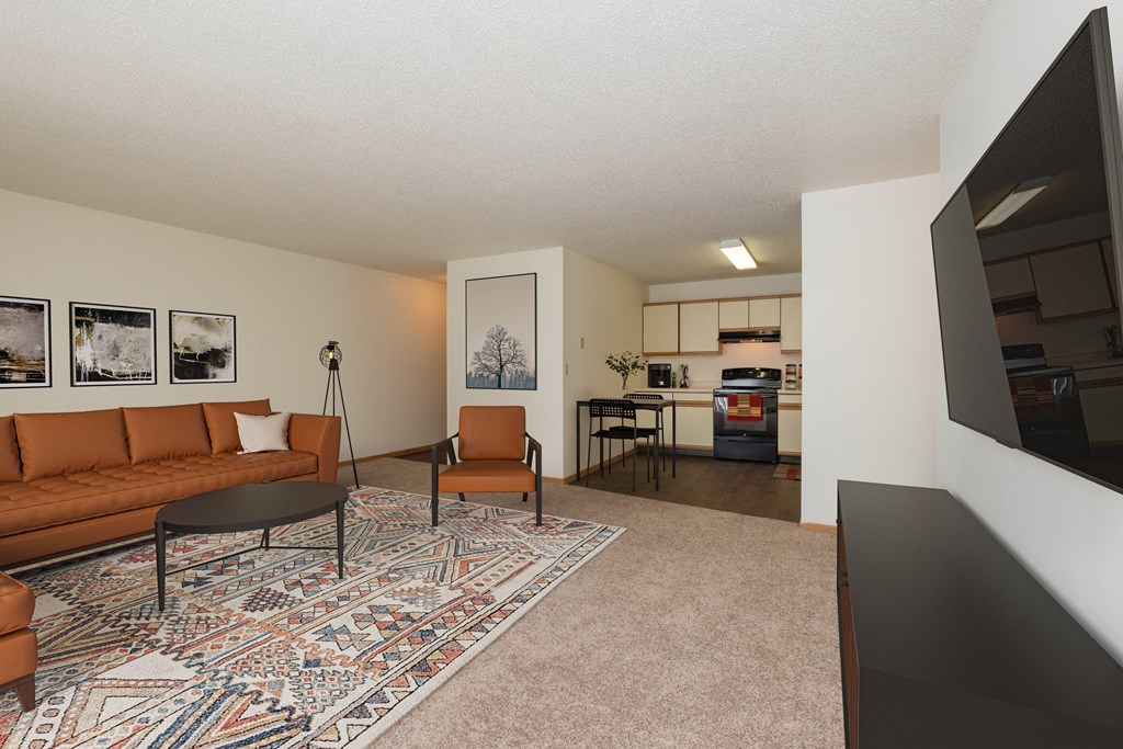 Fargo, ND Twin Parks Apartments. a living room with a brown couch and a black coffee table