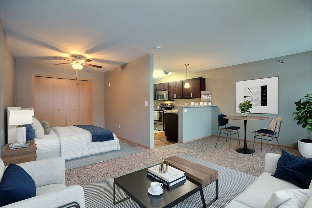 a living room and kitchen with a couch and a table. Fargo, ND Urban Plains Apartments