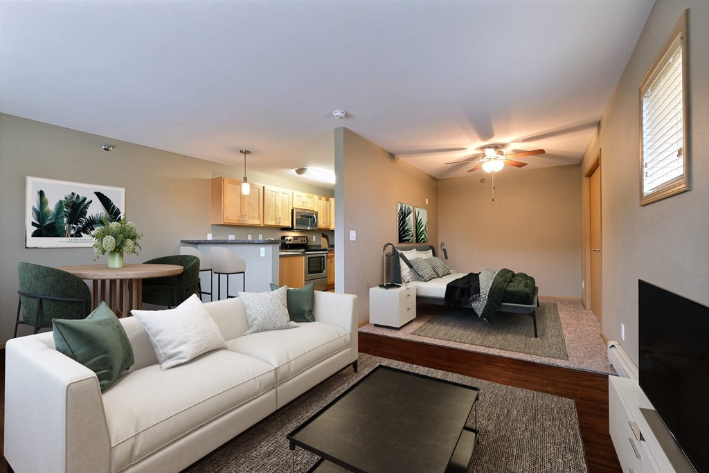 a living room with a white couch and a table. Fargo, ND Urban Plains Apartments