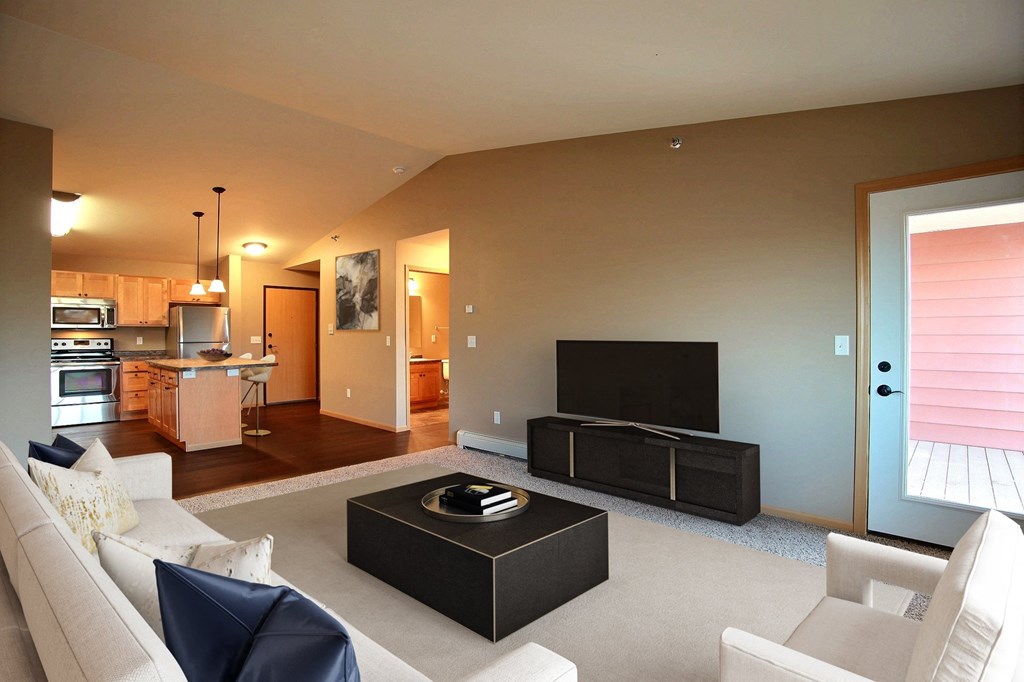 a living room with a couch and a tv. Fargo, ND Urban Plains Apartments