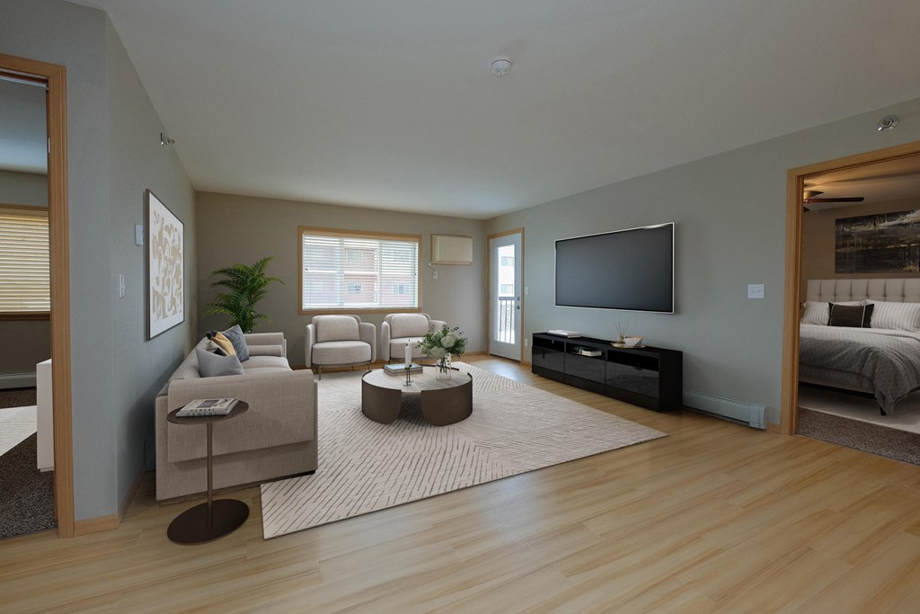 a living room with a rug and a couch and a television. Fargo, ND Urban Plains Apartments