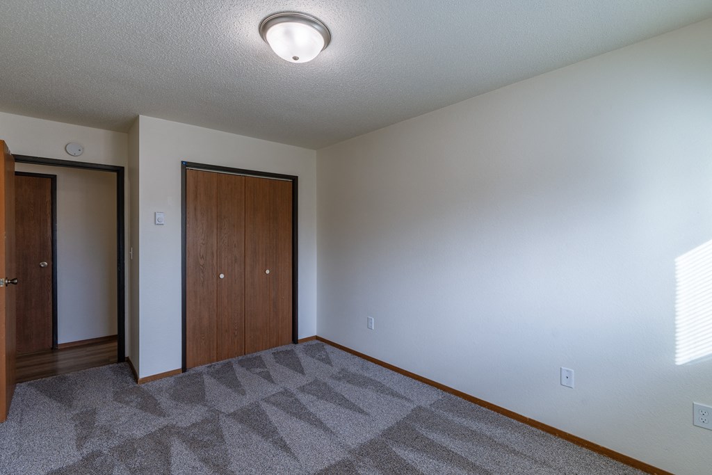 a bedroom with a closet. Fargo, ND Village West Apartments