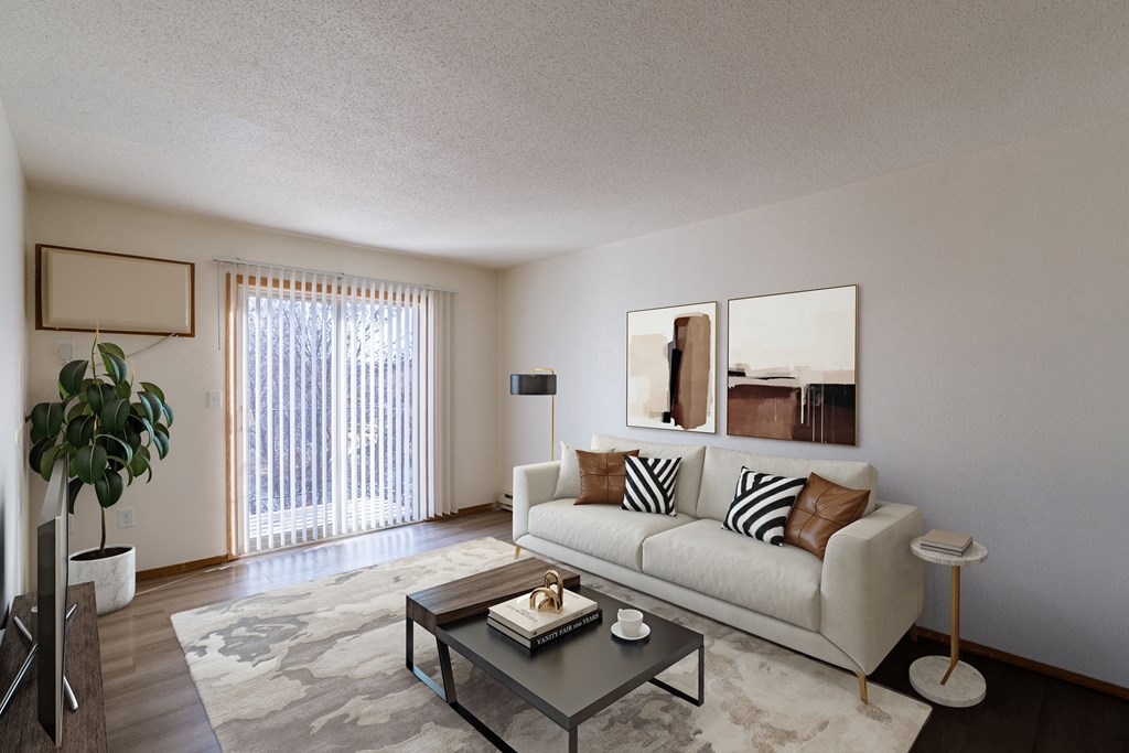 a living room with a couch and a coffee table. Fargo, ND Village West Apartments