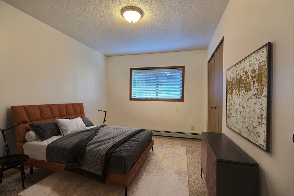 Fargo, ND Westcourt Apartments. bedroom with a bed and a window