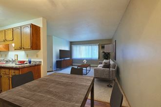 Fargo, ND Westcourt Apartments.  a kitchen and living room with a table and chairs