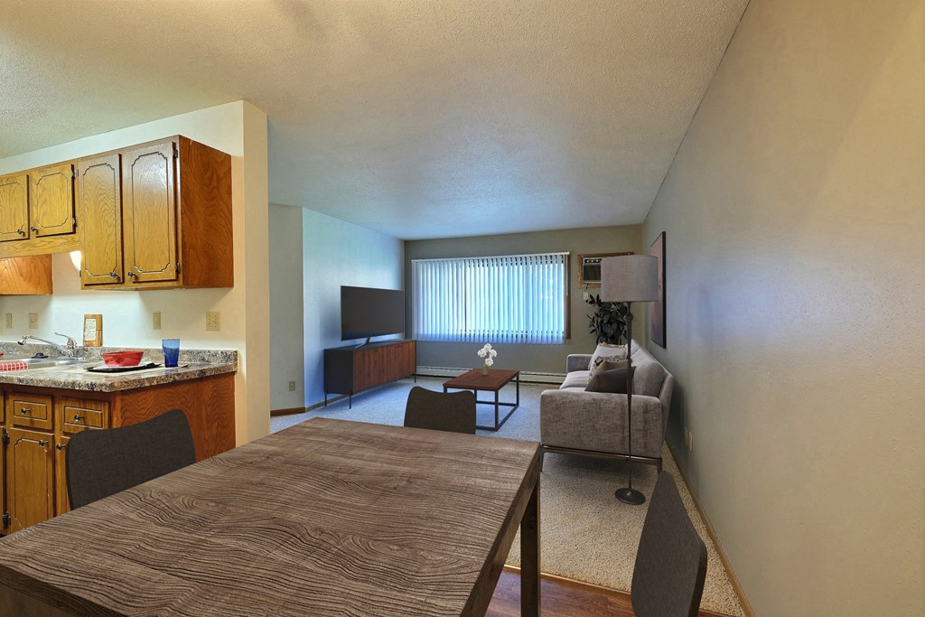 Fargo, ND Westcourt Apartments.  a kitchen and living room with a table and chairs