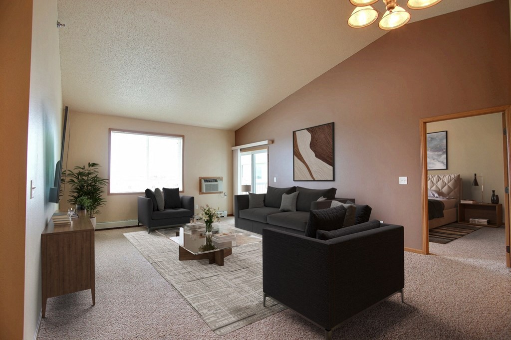a living room with a couch and a table. West Fargo, ND West Lake Apartments.
