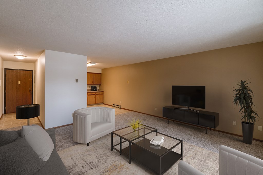 a living room with a couch and a coffee table. Fargo, ND West Oak Apartments