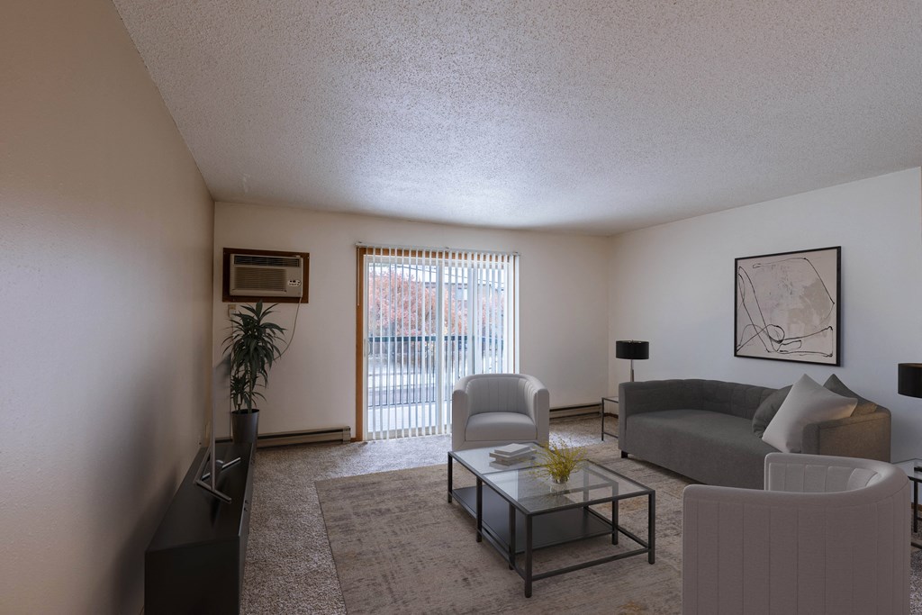 an apartment living room with a couch and a coffee table. Fargo, ND West Oak Apartments