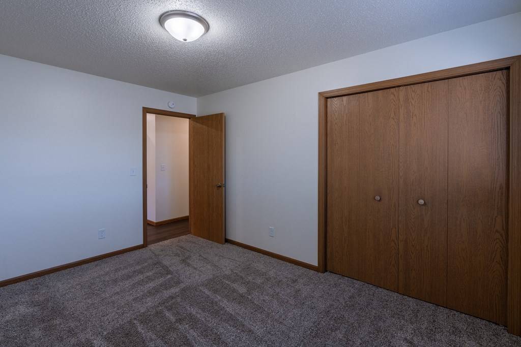 a bedroom with a closet. Fargo, ND Westwood Apartments