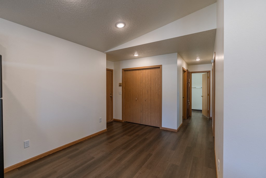 a dining room with a closet and the entry door with a hallway. Fargo, ND Westwood Apartments
