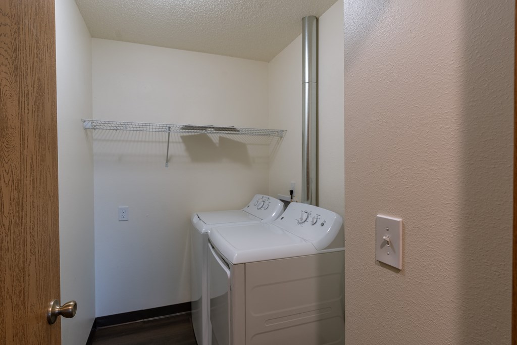 a laundry room with a washer and dryer. Fargo, ND Westwood Apartments