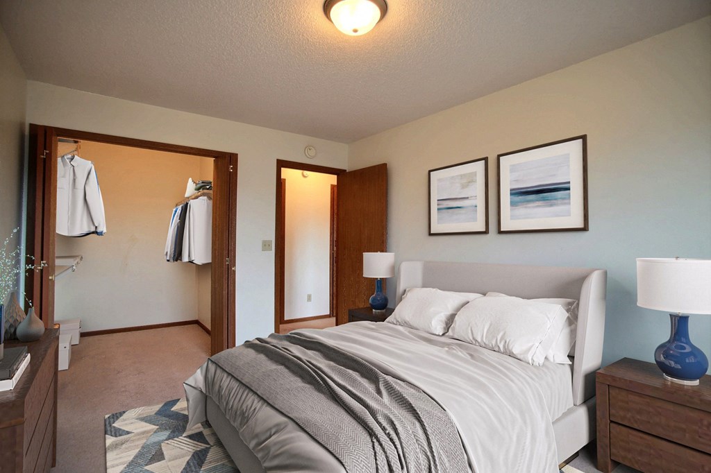 a bedroom with a bed and two night stands. Fargo, ND Westwood Estates Apartments