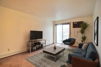Fargo, ND Westwood Estates Apartments. a living room with a couch coffee table and tv