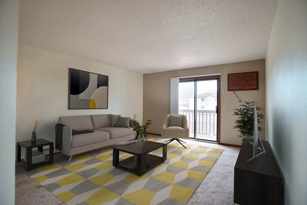 a living room with a yellow and gray rug. Fargo, ND Westwood Estates Apartments