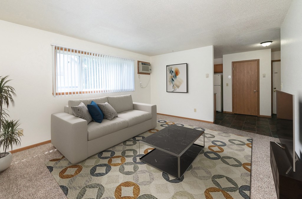 a living room with a couch and a coffee table. Fargo, ND White Ridge Apartments