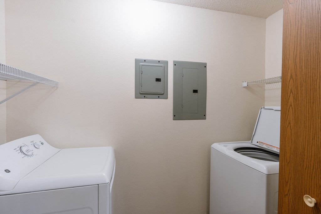 a laundry room with a washer and dryer. Fargo, ND Willow Park Apartments