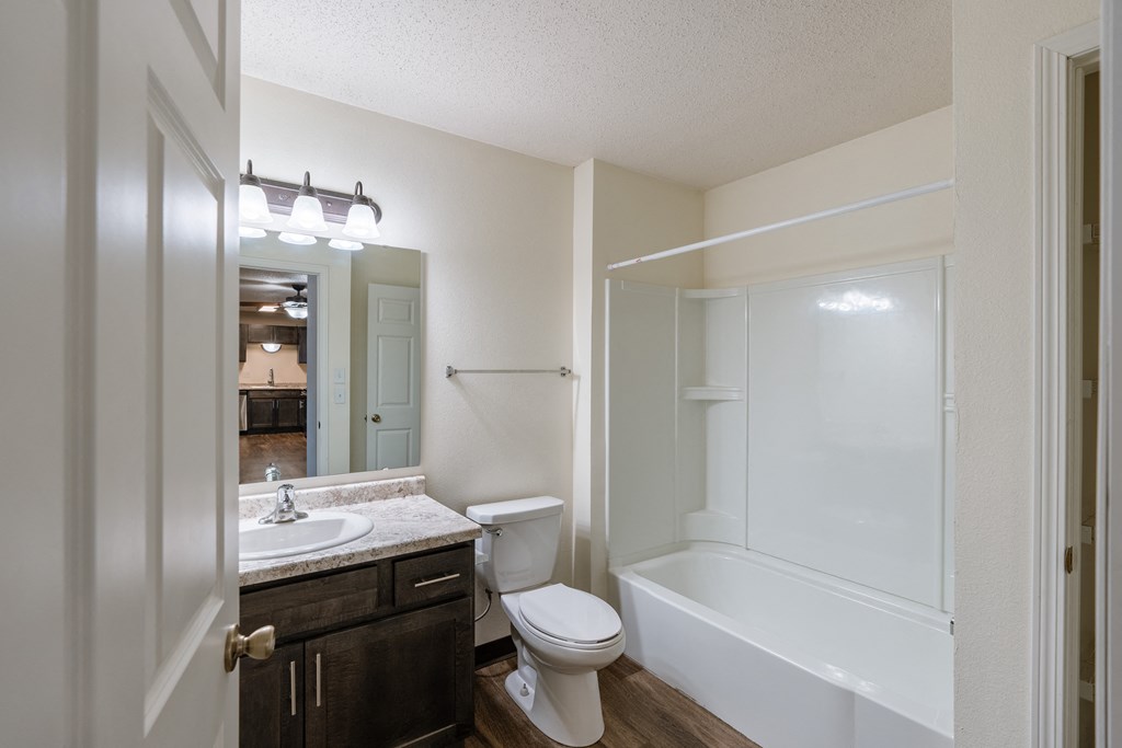 a bathroom with a sink and a toilet and a shower. Fargo, ND Willow Park Apartments