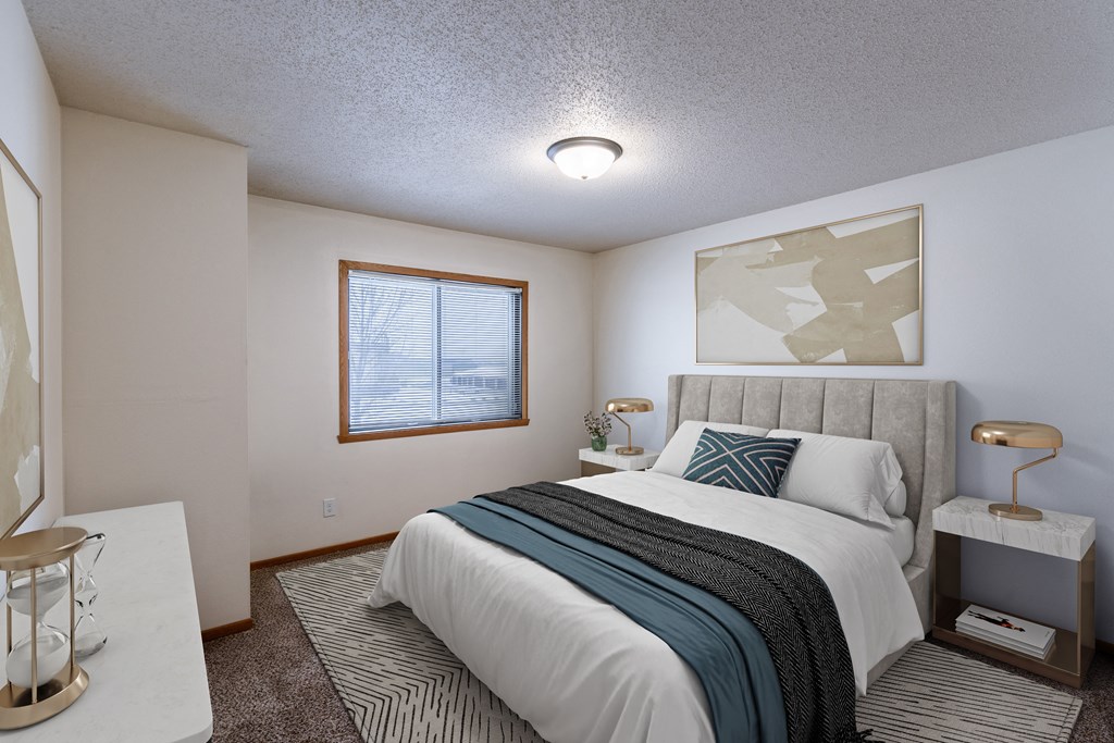 a bedroom with a bed and a window. Fargo, ND Willow Park Apartments