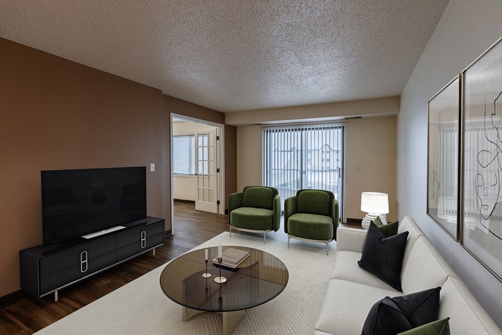 a living room with a couch and a coffee table and a television. Fargo, ND Willow Park Apartments