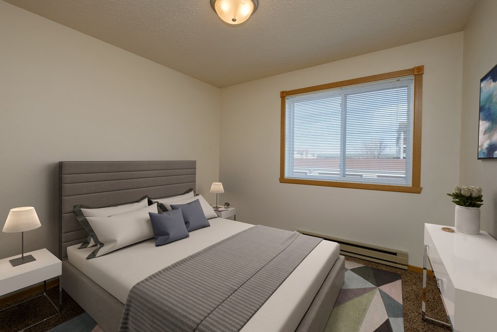 Fargo, ND Windgate Apartments. a bedroom with a large bed and a large window the brightens the room