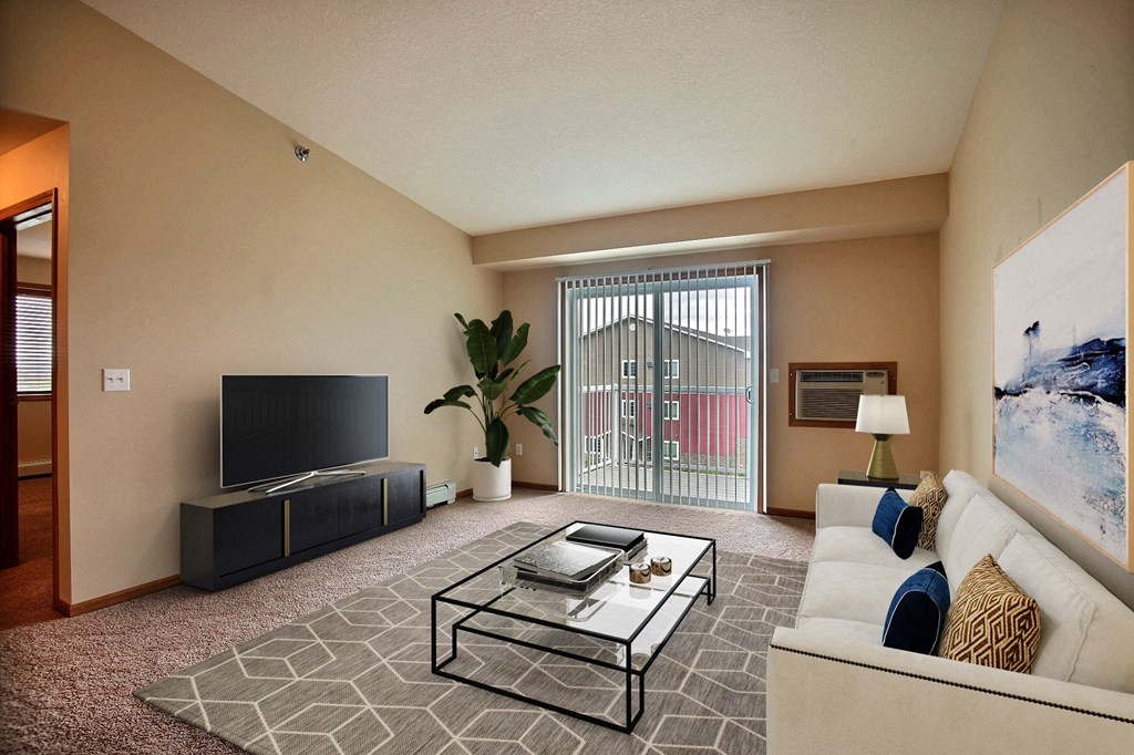 a living room with a couch and a coffee table. Fargo, ND Wolf Creek Apartments