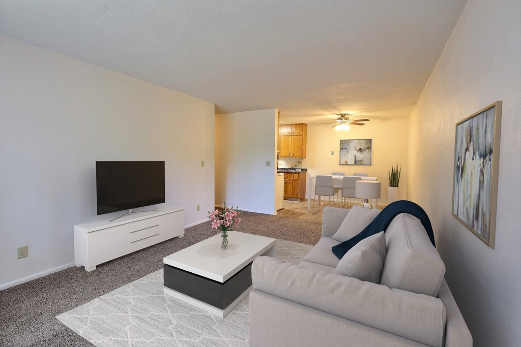 a living room with a couch and a coffee table. Fargo, ND Woodland Apartments