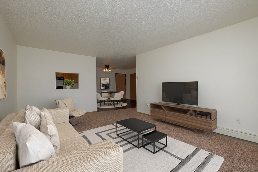 a living room with a couch and a coffee table. Moorhead, MN Woodstone Apartments