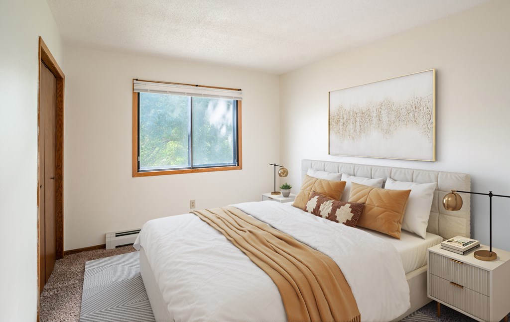 Fargo, ND Brookfield Apartments | 21A | Bedroom a bedroom with a large bed and a window. Fargo, ND Brookfield Apartments