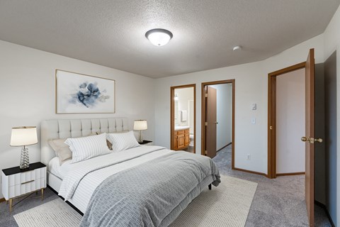 a bedroom with a bed and a closet. Fargo, ND Brownstone Apartments
