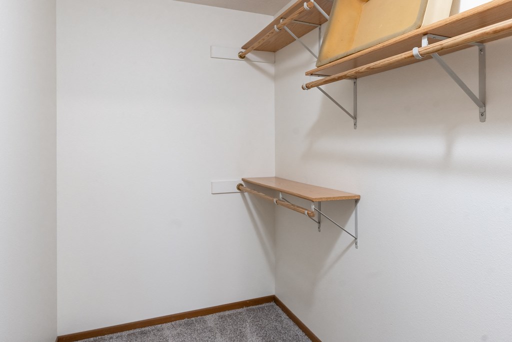 a walk in closet with shelves and a window. Fargo, ND Brownstone Apartments