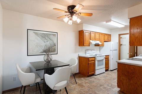 an open kitchen and dining area with a table and chairs