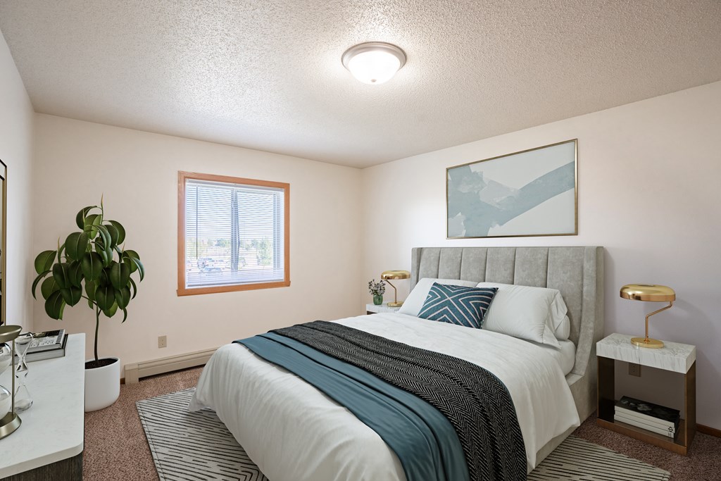Fargo, ND Carlton Place Apartments | 21C | Bedroom an empty bedroom with a bed and a plant. Fargo, ND Carlton Place Apartments