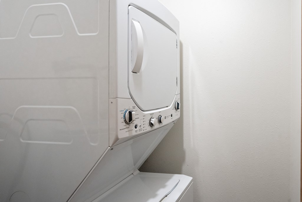 a washer and dryer in a small laundry room. Fargo, ND Cedar Pointe Apartments