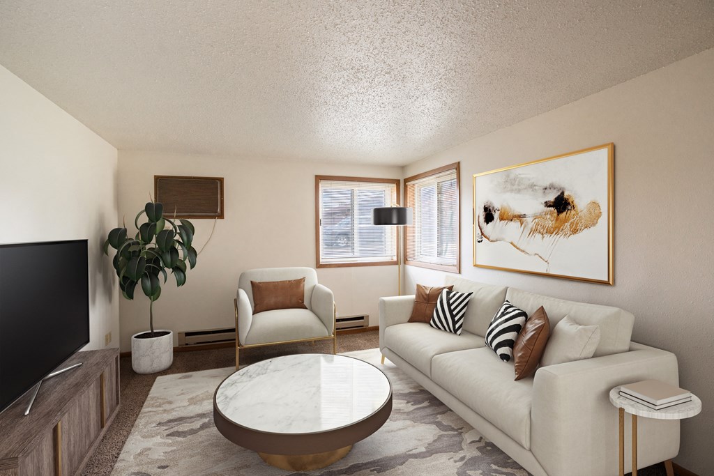 a living room with couches and a table. Fargo, ND Cedar Pointe Apartments