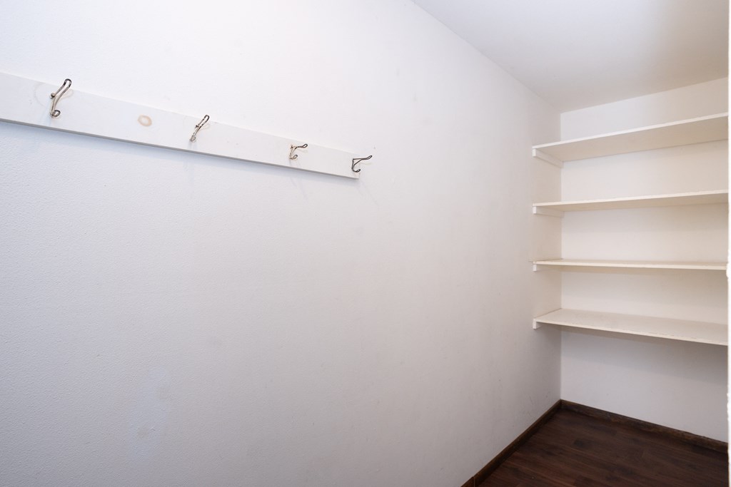 a room with white walls and shelves and a white shelf on the wall. Fargo, ND Country Club Apartments