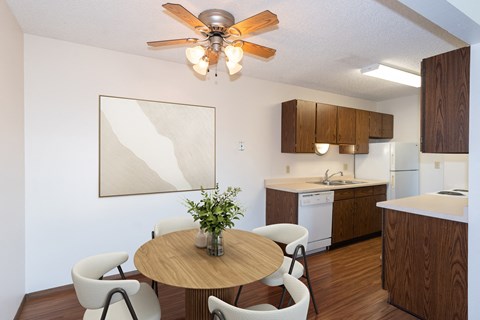 Fargo, ND Hartford Apartments | 11A | Dining a kitchen and dining room with a table and chairs and a ceiling fan. Fargo, ND Hartford Apartments