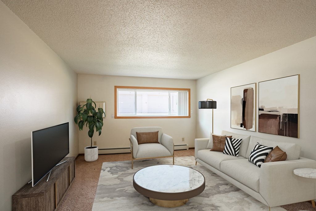 a living room with a couch and a coffee table and a tv. Fargo, ND Hawn Apartments