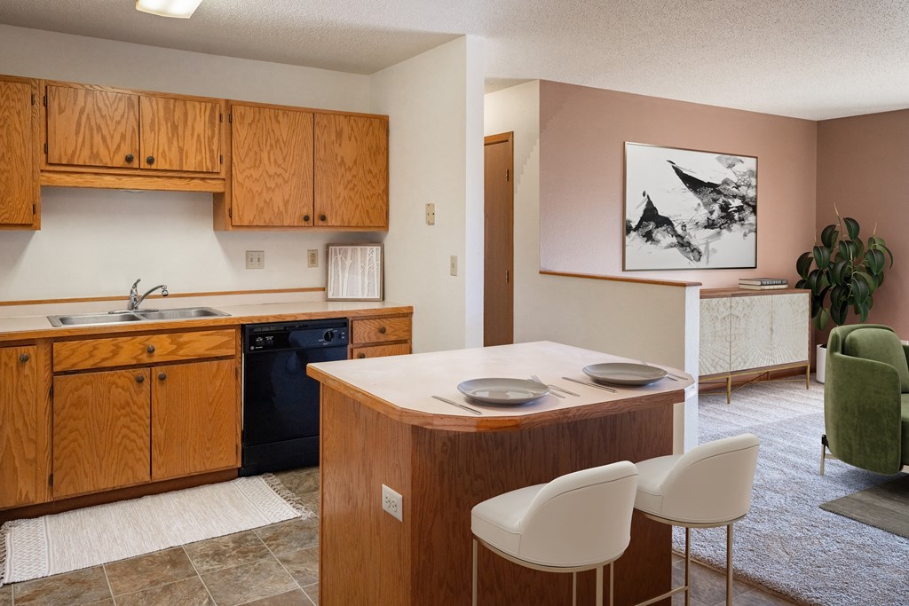a kitchen with a island and a sink and a black dishwasher. Fargo, ND Hunters Run 2 Apartments